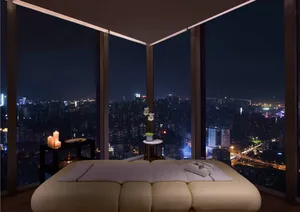 A spa room featuring a comfortable white leather couch, white towels, a small round table with a white floral centerpiece and