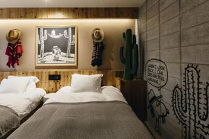 A rustic, industrial-themed bedroom with wooden furniture and wall art