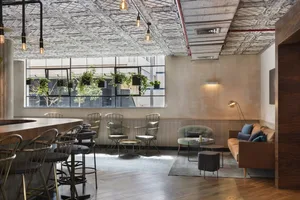 A modern industrial-style coffee bar with metal elements, featuring sleek seating and a sleek counter.
