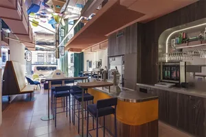 A modern, stylish bar area with wooden and metallic accents.