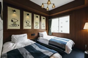 A modern hotel room with wooden walls and a window.