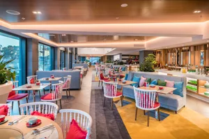 Modern restaurant interior with concrete, wood, and glass materials