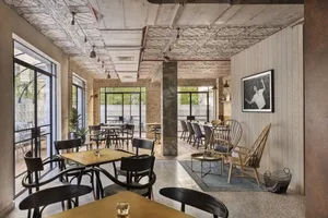 Industrial style restaurant interior with brick walls, concrete floors, and eclectic artifacts