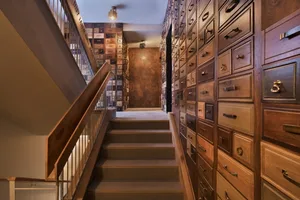 A modern industrial staircase with wooden steps and railings