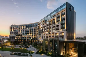 Modern hotel exterior with concrete, glass, and aluminum materials