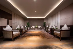 A modern furniture showroom featuring plush, textured fabric armchairs and sofas.