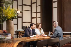 A modern office interior featuring wooden furniture and a well-lit workspace.