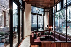 Modern, industrial restaurant interior with brick walls, concrete floors and wooden accents.