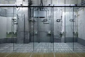 Industrial-style shower rooms featuring concrete and glass materials.