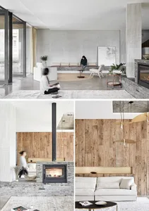 A minimalist living room with concrete walls, a wood wall, and a fireplace.