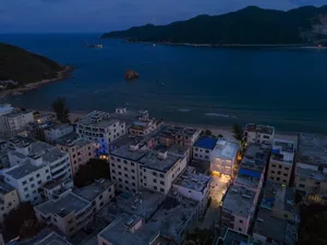 Aerial view of modern architectural design featuring concrete structures by a body of water.