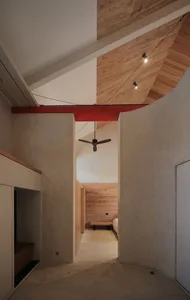 A modern house with a combination of concrete walls and wooden paneling.