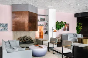 Modern living room with concrete fireplace and copper accents.