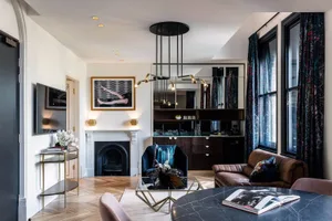 A modern living room featuring marble flooring and furniture.