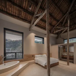 Modern luxury residential suite featuring a wood-paneled ceiling, large windows, and a bathtub with a view.