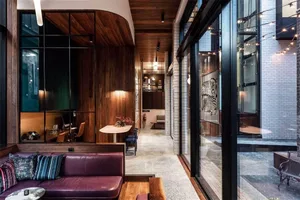 Modern office space design featuring concrete and glass materials.