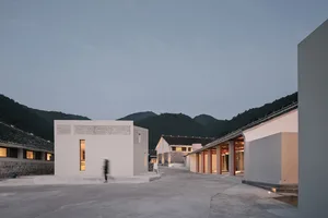 A modern white box building constructed of concrete materials.