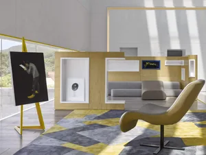 A minimalist living room with wood-paneled walls, a grey sofa, and a yellow leather armchair.