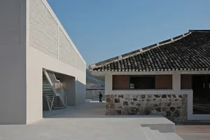 Modern architectural building with concrete walls and tiled roof