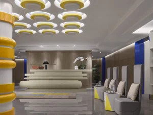 Contemporary lobby featuring modern construction materials, including concrete and yellow accents.