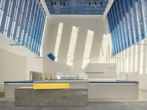 Modern retail shop interior featuring glass walls and marble accents.