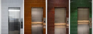 Four elevator doors framed by multicolored tiles with metal panels
