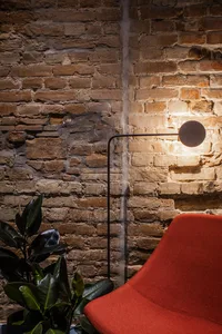 A cozy modern living room featuring rustic brick walls and contemporary furniture.