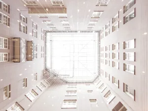 A modern office space with a concrete ceiling and geometric lighting design.