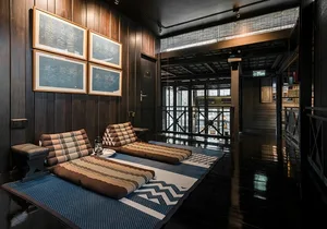 A minimalist living area with wooden walls and comforts of soft textiles