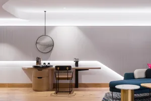 Modern living room featuring wooden furnishings, a comfortable sofa, and a cozy atmosphere.