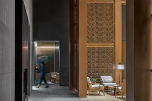 A modern lobby featuring wooden paneling and contemporary furniture.