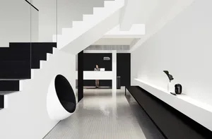 A modern, minimalist reception area with a metal staircase and desk.