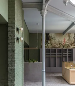 An interior view of a modern retail storefront featuring concrete walls and floor.