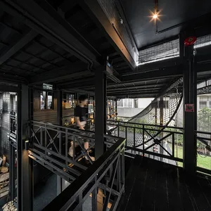 A modern coffee shop with black wooden panels and an industrial design aesthetic.