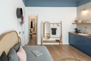 A modern bedroom with a wooden bed and a grated wooden roof