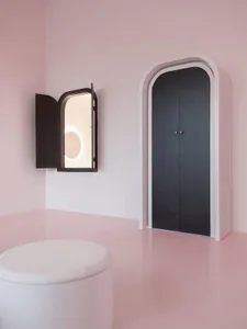 A minimalist interior design featuring arched lighting and walls made of plaster and metal.