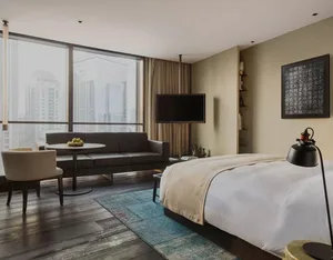 Modern hotel suite featuring a combination of wood and textiles for a contemporary and stylish ambiance.