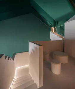 Modern interior space with concrete walls, floors, and lamp, featuring geometric shapes and minimalist design.