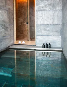 Modern spa pool area with glass water and minimalist design