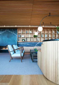 Modern lobby featuring wooden furniture and materials.