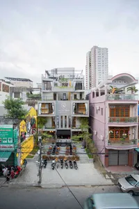 Condominium building with rooftop terrace, bicycle racks, and urban street view.