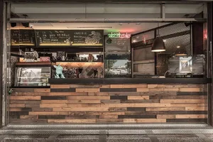Modern coffee shop storefront with wooden counter and menu chalkboard
