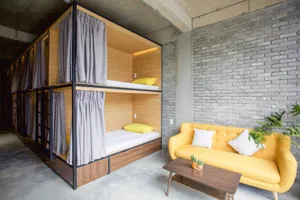 Industrial-style accommodation featuring a wooden watchtower and concrete elements.