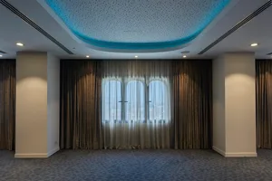 A modern conference room with curtains covering the windows.