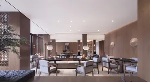 A modern hotel lounge featuring a contemporary design with wooden textures.