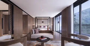 Modern hotel bedroom with wooden furniture and a view of the mountains.