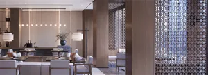 Modern living room featuring a wood ceiling panel, white sofas, and an open layout.