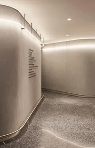 A modern lobby featuring concrete walls and flooring.