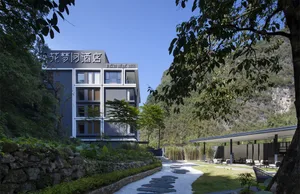 Outdoor view of a modern resort hotel with concrete exterior and greenery.