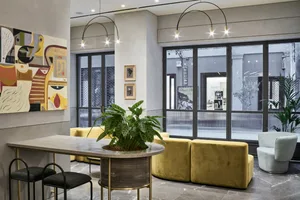 A modern retail space featuring a concrete floor and glass window displays.